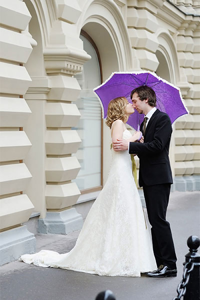 newlyweds with umbrella